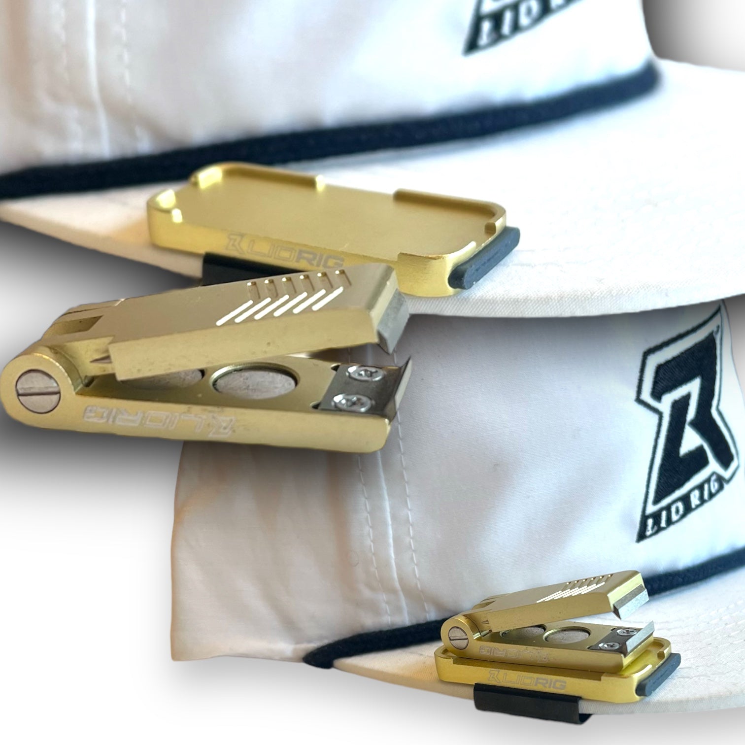 A gold Lid Rig 3.0 magnetic nipper docked on a gold Stash Tray, both clipped to the brim of a white Lid Rig ballcap (photo: Lid Rig)